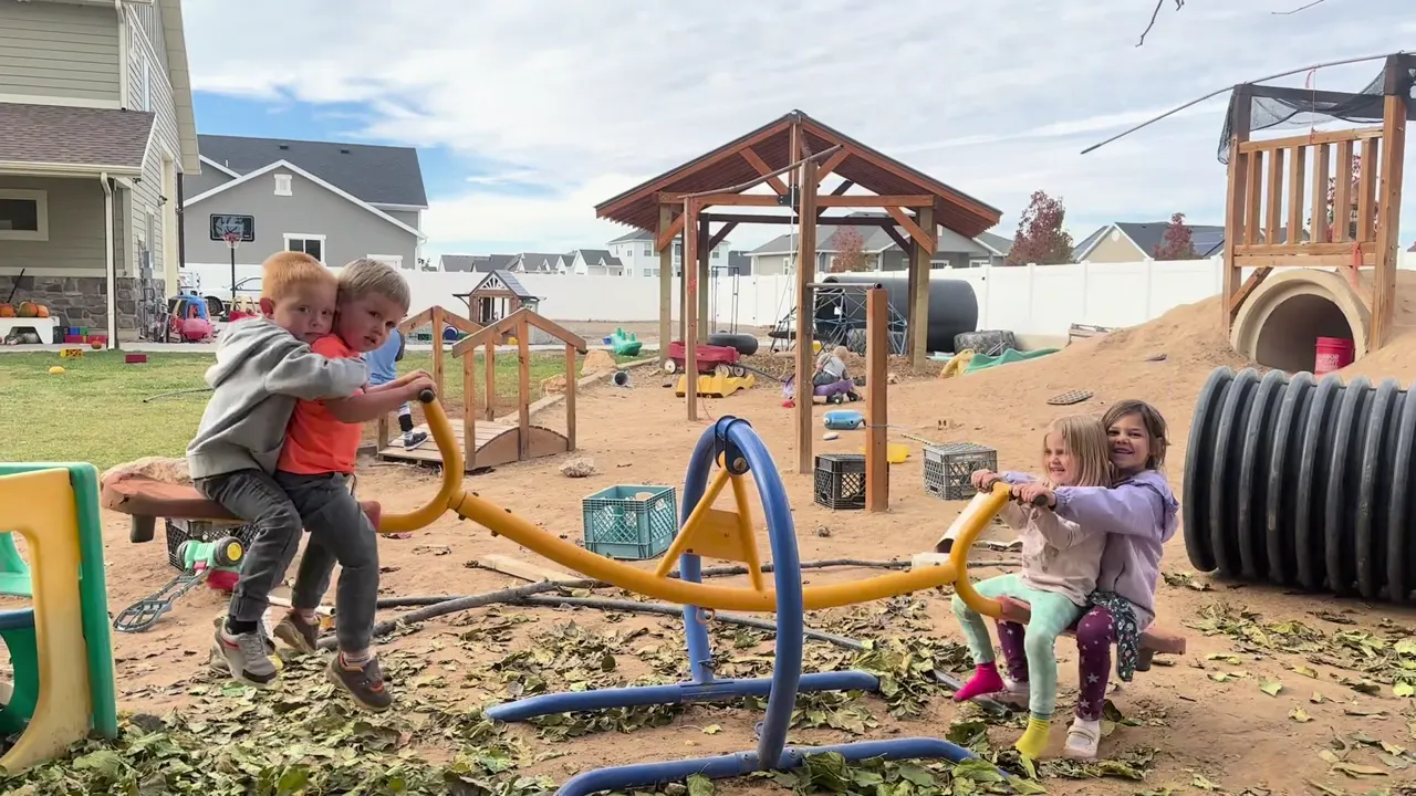 Children playing together on outdoor play equipment in the Dirt Learning play yard